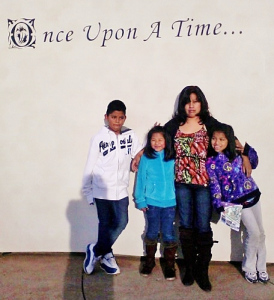 Maria Juana hugs her young family that includes her three children.